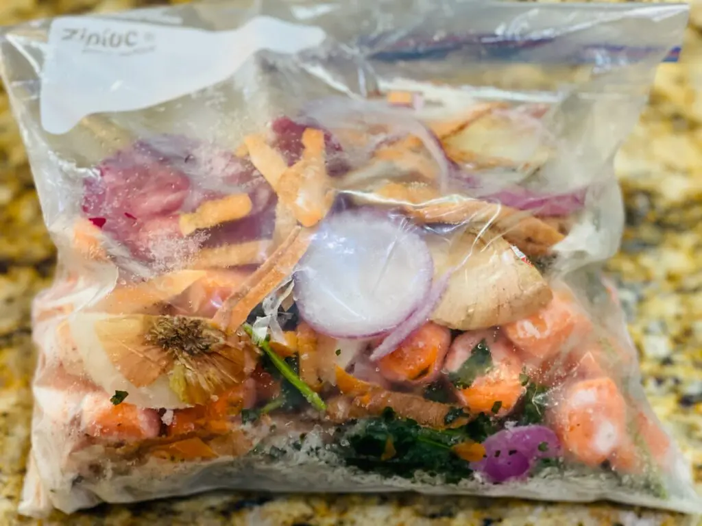 frozen vegetable scraps in a gallon-sized freezer bag - Domestic Gourmet