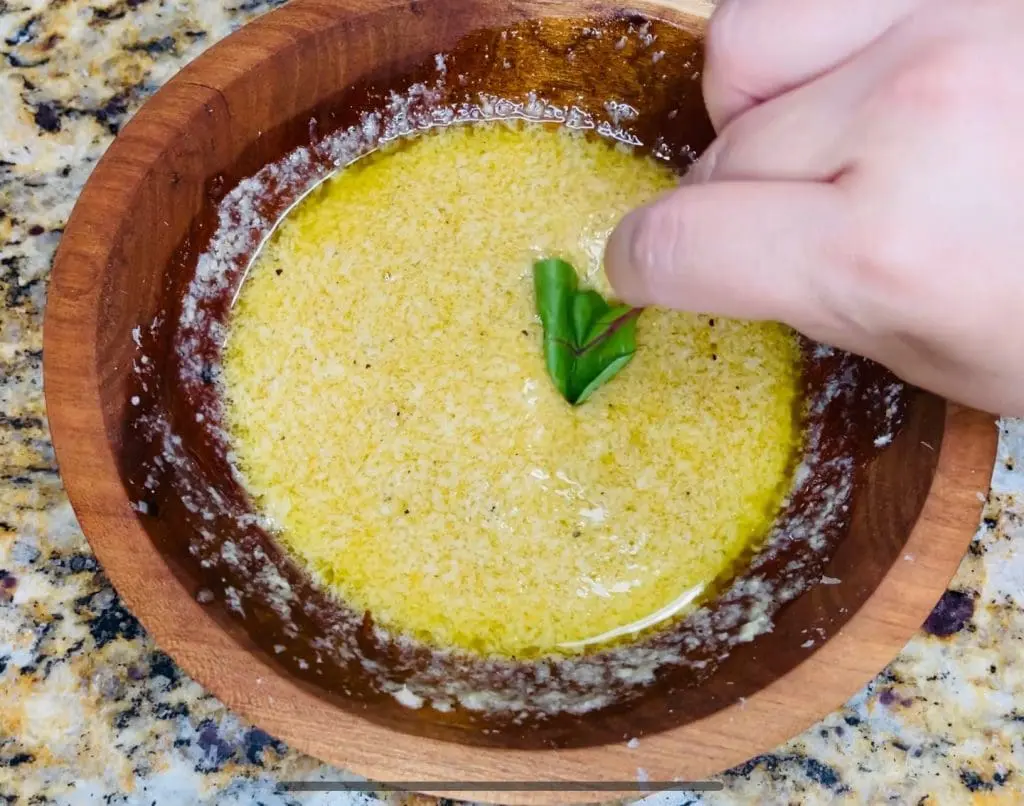 Using a leaf to taste Dijon Vinaigrette substitute the olive oil with Domestic Gourmet Organic Annatto Oil - Aceite de Achiote for richer color and flavor