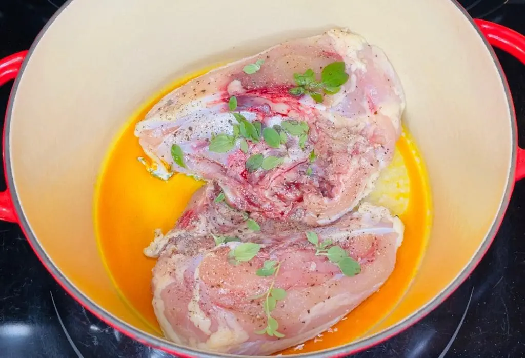 seasoned chicken breasts searing in Domestic Gourmet Organic Annatto oil - Aceite de Achiote for Latin American Chicken Noodle Soup / Sopa de Pollo con Fideos