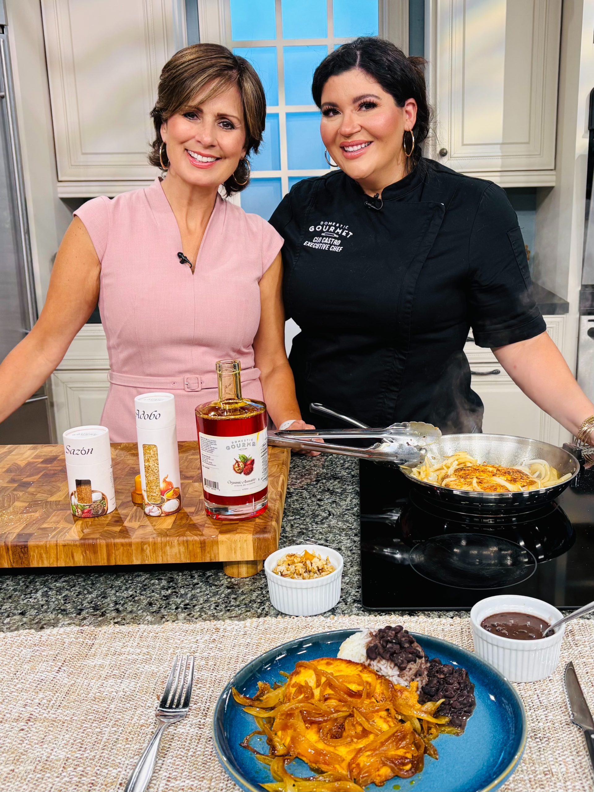 Chef Ciji Castro and WFLA's Daytime TV Host Maggie Rodriguez making Mimis Chicken - Pollo Encebollado made with Domestic Gourmet Annatto Oil, Sazón and Adobo